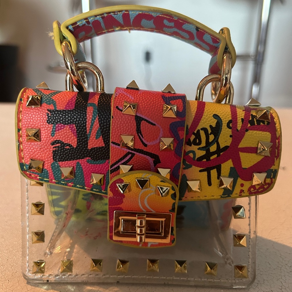 Graffiti studded clear mini bag.